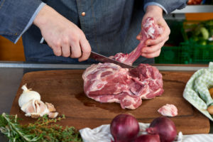 Photo series, step-by-step preparation of a leg of lamb filled with herbs and Provençal vegetables by using a food processor (Thermomix ® and Varoma ®), cutting the leg of lamb, deboning Photo series, step-by-step preparation of a leg of lamb filled with herbs and Provençal vegetables by using a food processor (Thermomix ® and Varoma ®), cutting the leg of lamb, deboning